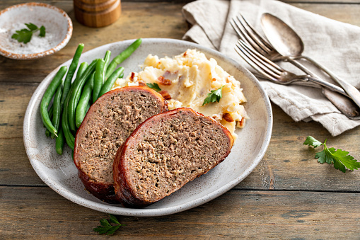 Meatloaf with mashed potatoes and green beans, traditional dinner meal, serving on a plateMeatloaf with mashed potatoes and green beans, traditional dinner meal, serving on a plate